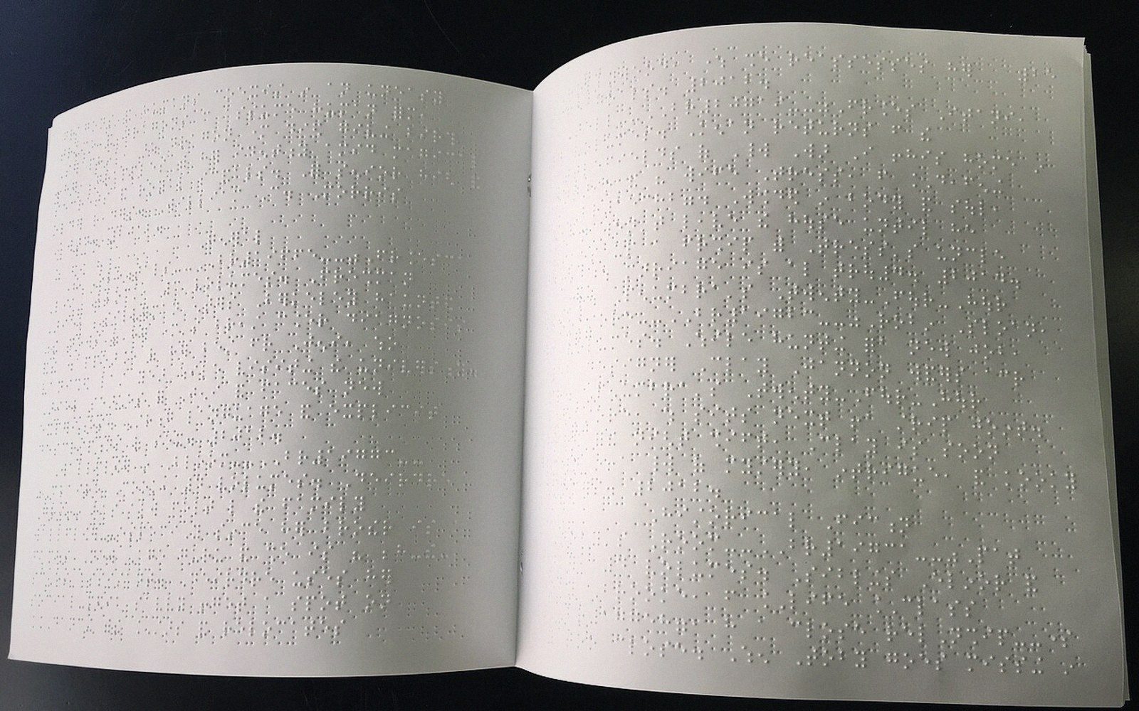 Heavy braille paper stacked beside a guillotine