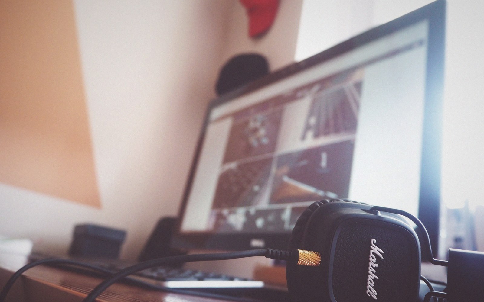 A transcription desk with a screen, headphones and a marked-up manuscript